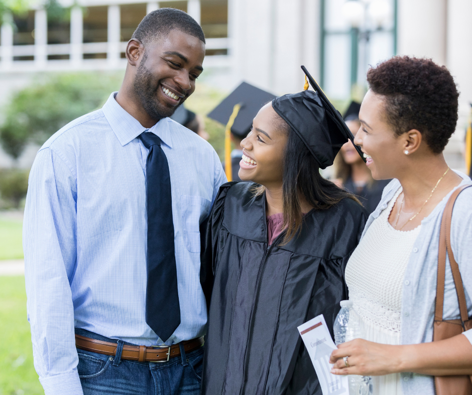 An image of a young woman who just graduated, in between her parents who are smiling at her, demonstrating that supporting your health during life transitions as a parent is very important.